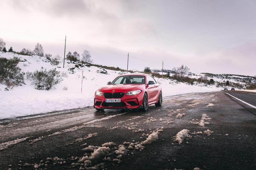Buy & Source Cars - Red BMW M2 on snowy road
